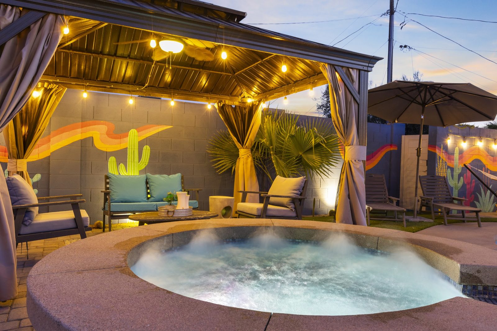 Hot tub staged under a lit pergola at a Scottsdale vacation rental