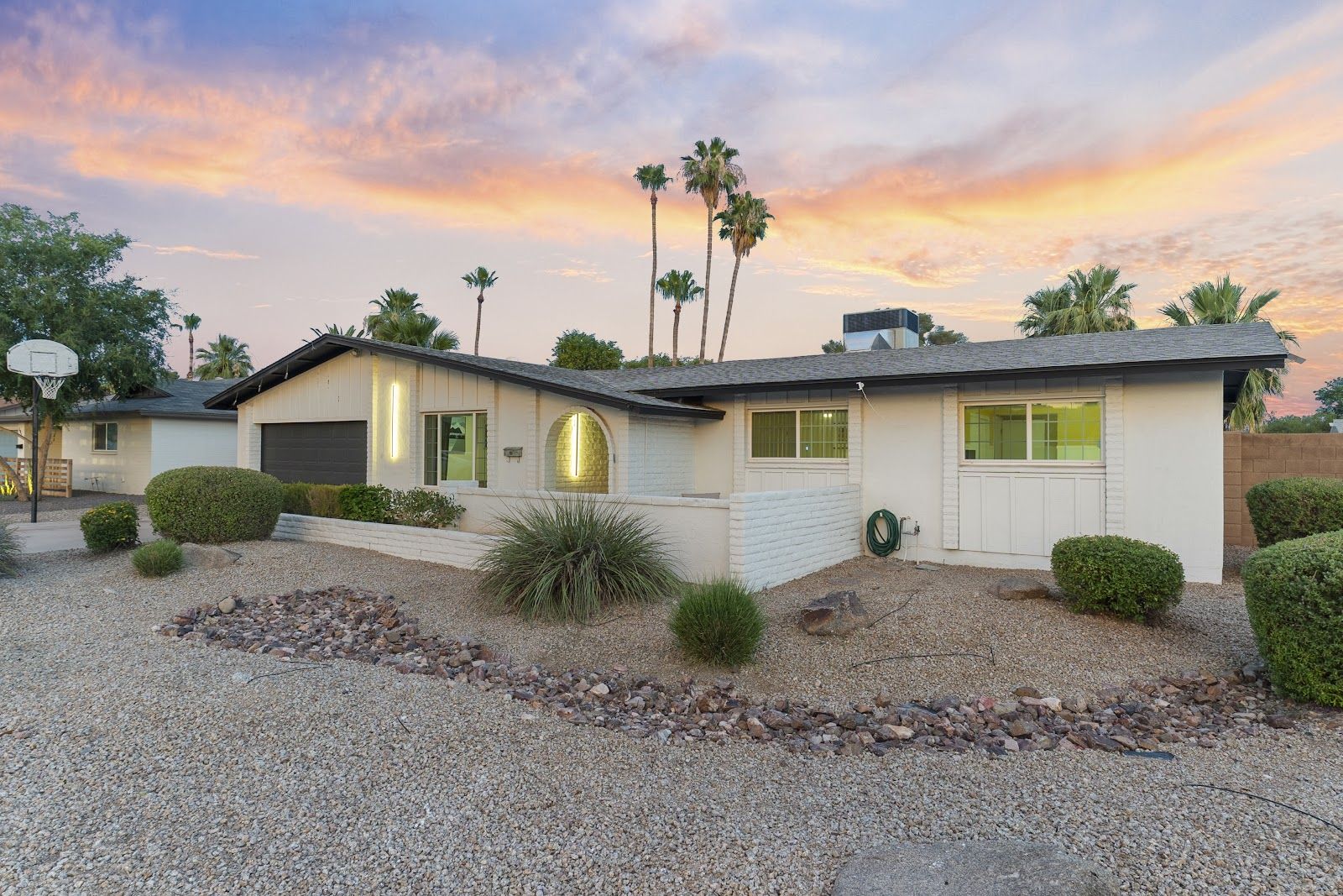 A recent Tempe 4-bedroom Airbnb shoot at twilight: the mid-century house lit under a sunset sky