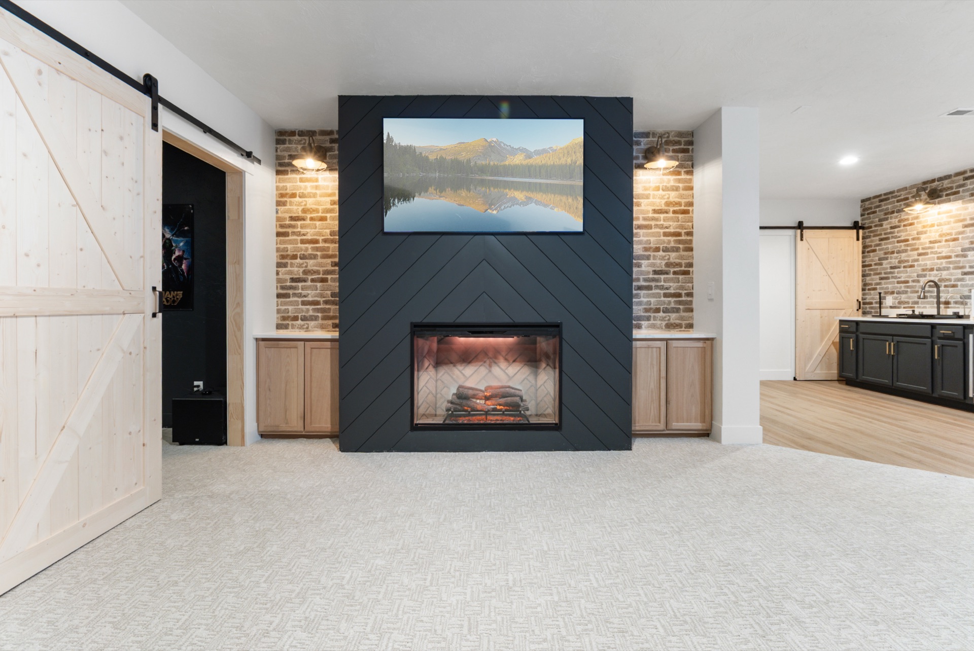 Basement media room with brick walls and barn doors