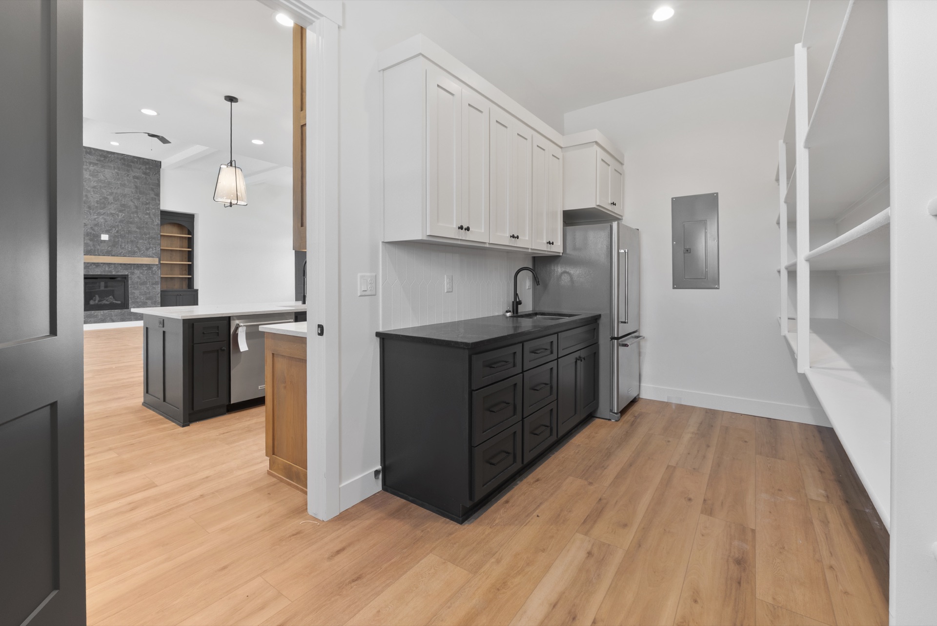Butler pantry prep kitchen with black cabinets and open shelving
